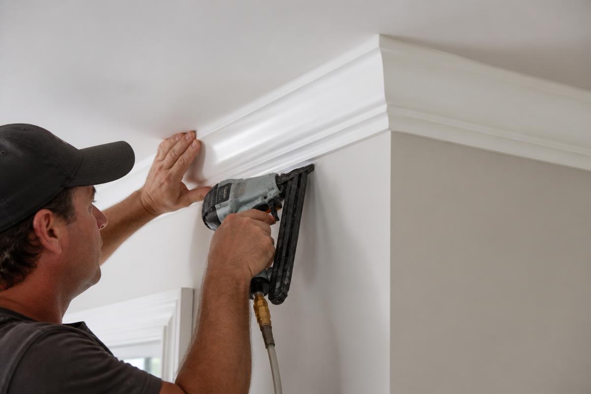 Carpenter installing crown molding trim in a Las Vegas home